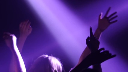 Under the spotlight, the girls are dancing in the club. Silhouette. Slow motion - Powered by Adobe