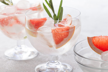 Citrus lemonade water with grapefruit sliced , healthy and detox water drink in summer on concrete table.