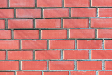 Wall from a red brick as an abstract background