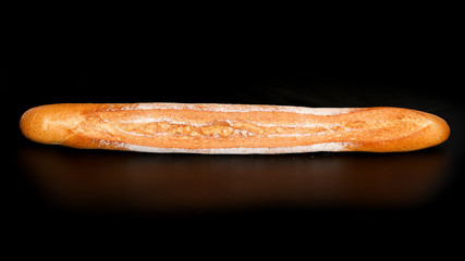 Fresh wheat bread on a black background
