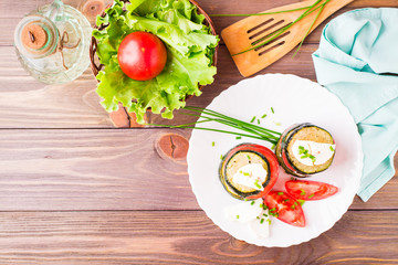Original appetizer from fried zucchini, fresh tomatoes and feta cheese on a wooden skewer on a plate. Copy space