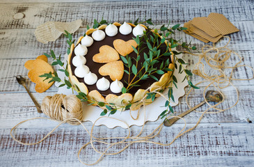 Cheesecake with gingerbread cookies on wood with greenery decoration