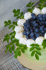 birthday cake wrapped in biscuit tape with blueberries and merengues
