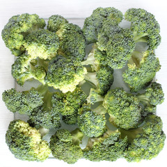 cooking green vegetables/ ripe broccoli cabbage on a cutting board top view 