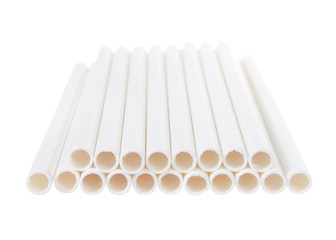 Close up on white paper straws laying flat isolated on white background.  ecologically friendly yet durable paper drinking straws.