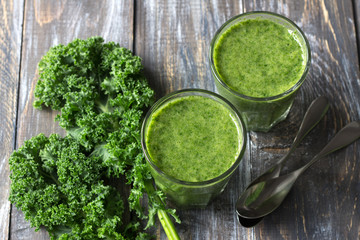 Green smoothies with kale, banana and lemon. on a wooden table. selective focus. healthy diet food