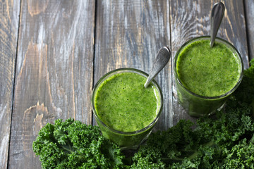 Green smoothies with kale, banana and lemon. on a wooden table. selective focus. free space. healthy diet food