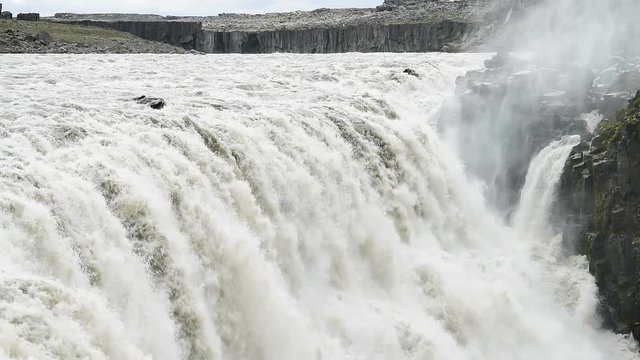 Iceland Dettifoss largest waterfall, gray grey water, rocky cliff and water flowing closeup, nobody