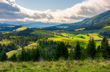 lovely rural area in mountains. huge cloud formation over the distant ridge. picturesque scenery of Carpathian alps