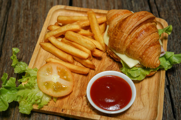 Croissant ham cheese delicious breakfast on wooden table