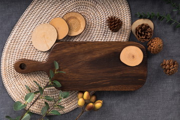 A wooden table with autumn feeling and a table with fruit. A well-being meal preparation on a tablecloth of gray color, a photo image of a chopping board picture usable as a dining table menu.