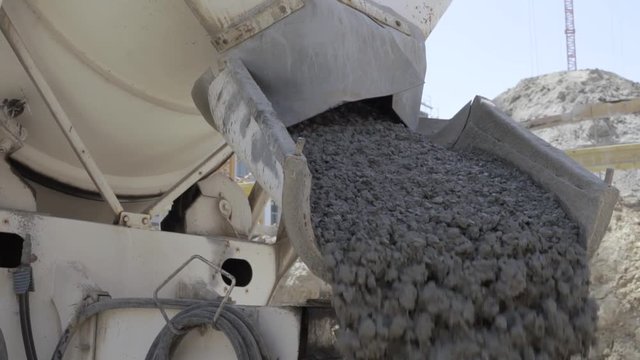 Cement being poured by truck on construction site