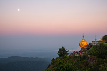 Fototapeta premium The scenery view of Kyaiktiyo pagoda or Golden rock pagoda under the moonlight before sunrise. 