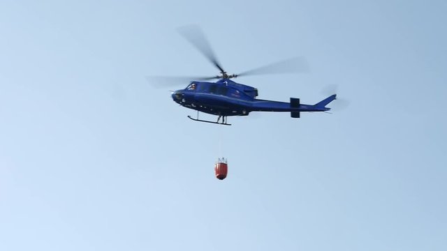 The fire brigade rescue helicopter carries water in the tank.