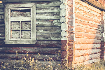 Old wooden house, log walls and window - rustic architecture