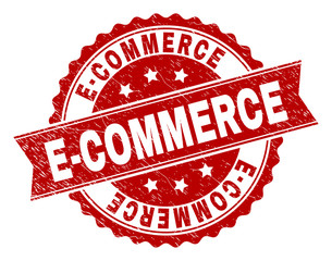E-COMMERCE seal stamp with corroded texture. Rubber seal imitation has circle medallion shape and contains ribbon. Red vector rubber print of E-COMMERCE title with dirty texture.