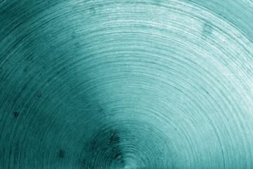 Old metal surface with scratches in cyan tone.