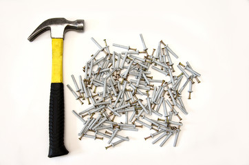 tools for construction, yellow hammer and dowel nails isolate on white background