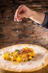 Chef in restaurant exclusively serves italian pasta pappardelle.