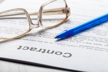 Close up shot of Eyeglasses  on contract document papers business concept