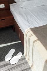 Obraz na płótnie Canvas Slippers on the floor of hotel room