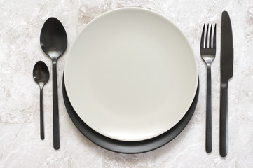 Black and white tableware on marble
