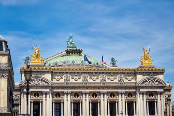 Fototapeta na wymiar Palais or Opera Garnier & The National Academy of Music (Grand Opéra). Detail of the main southern facade of the building with gold sculptures. Paris, France, Europe