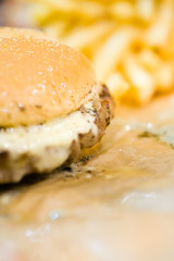 american beef hamburger with cheese and french fries at beautiful fast food and cafe bistro.delicious low price hamburger in budget.close up details of hamburger and chicken nuggets at fast food.