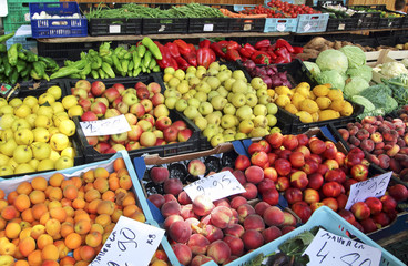 Fresh colorful fruits and vegetables on a market. Farmers street froit market with prices in euro in Spain.