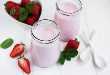 Jars with strawberry yogurt