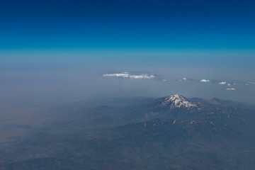 Aerial view of the mountain range with some snow on the top