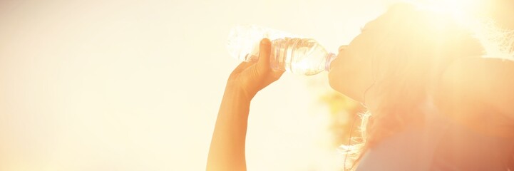 Fit blond drinking from her water bottle