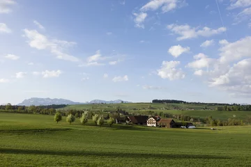 Fotobehang Lente Farm in central Switzerland on a sunny spring day near Nottwil. In the background Mount Pilatus  © Fredy Thürig
