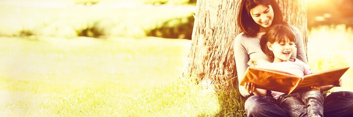 Radiant mother with her daughter looking at their photo album 