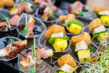 Tasty snacks with cheese and fish on the buffet table