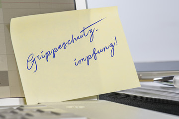 Notizzettel an Computermonitor Grippeschutzimpfung