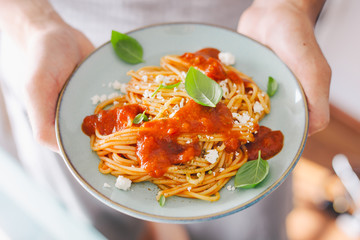 Young man holding eating tasty italian pasta. Healthy eating concept