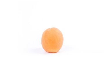 Several of harvested apricots whole and halved on white background..