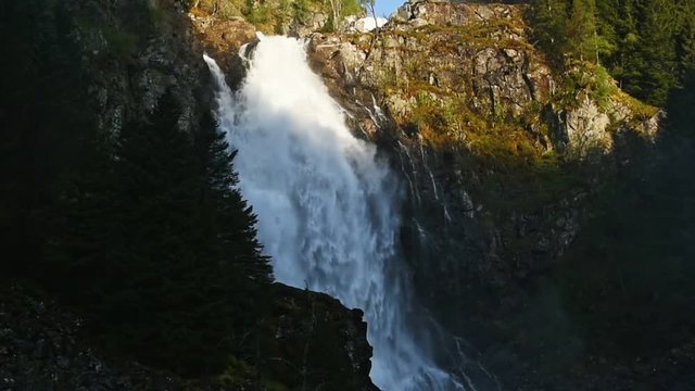 The waterfall Espelandsfossen just south of Odda in Hordaland, Norway. Here on a sunny morning in late May with only the top part in sunshine.