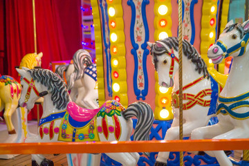 colorful merry-go-round horses in an amusement park