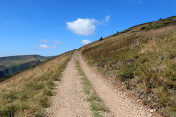 Earth road in mountains