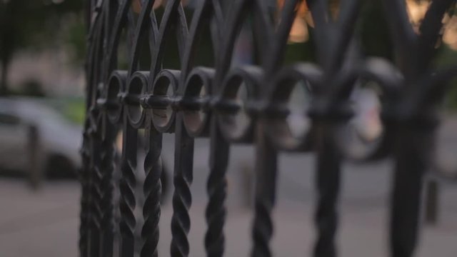 close up focuss pull of a hand rail in the middle of a buisy city