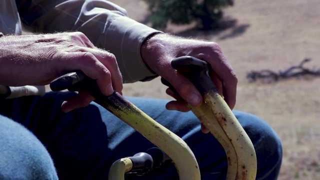 Backhoe tractor digging up a leaking water line on a hot day