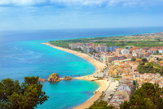 Rock Sa Palomera on coast of Spanish beach resort Blanes in summertime. Sunny view from height of mountain of castle San Juan. Costa Brava, Catalonia, Spain