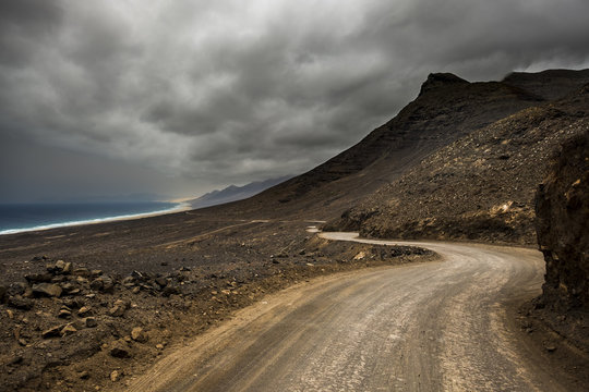 Long Infinite Off Road Path. Wild Beach And Mountains Destination. Alternative Place For Traveler Vacation. Lost In Wanderlust Exploring The World In Different Way. Beautiful Landscape With Ocean