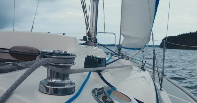POV yacht sailing on a large lake, rainstorm in the background, bad rainy weather. 4K UHD 60 FPS SLO MO
