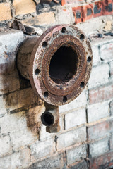 old rusty pipes in the destroyed boiler room
