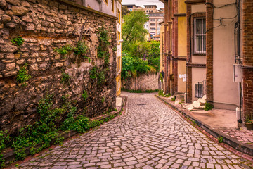 Fototapeta na wymiar Vintage view of Traditional street and houses at balat area.Street view in historical Balat district. Balat is popular attraction in Istanbul.