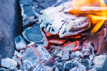 Burning coals in the grill. Shallow depth of field.