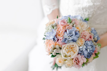 Rose gold wedding rings lying on the top of bouquet